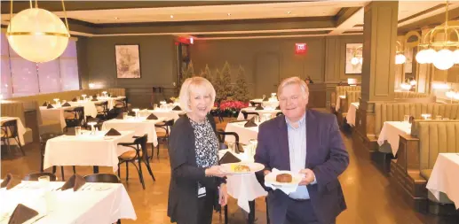  ?? RYAN KNELLER PHOTOS/THE MORNING CALL ?? Westside Grill’s restaurant manager Eileen Casale holds a lump crab cake, while Scott Craver, manager of the Hyatt Place and Hyatt Hotels, holds a 6-ounce filet in the restaurant’s dining room.