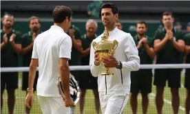  ??  ?? Victor and vanquished: Novak Djokovic walks past Roger Federer after beating him for the third time in a Wimbledon final on Sunday. Photograph: Ben Stansall/AFP/Getty Images