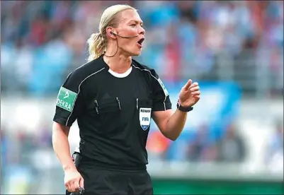  ?? HANNIBAL HANSCHKE / REUTERS ?? Bibiana Steinhaus, who will become the Bundesliga’s first female referee this season, shouts orders during Bayern Munich’s German Cup 5-0 victory over Chemnitzer last Saturday.