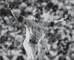  ?? TORONTO STAR FILE PHOTO ?? Roberto Alomar salutes his game-tying home run in the ninth inning of Game 4 of the 1992 American League Championsh­ip Series. The Jays won, 7-6 in extra innings.