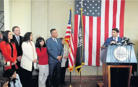  ?? PHOTO BY DAVID SOUZA / THE HERALD NEWS ?? FAMILY SUPPORT: Family and supporters of Fall River Mayor Jasiel Correia listen while he tells his side of the story about his indictment during a press conference yesterday.