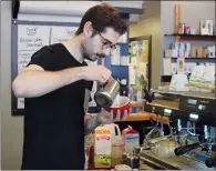  ?? NEWS PHOTO MO CRANKER ?? Barista Ari Warhaft pours a latte Monday afternoon at Station Street Coffee Co. The cafe is one of 12-18 businesses that will open its doors from 6-8 p.m. Thursday as part of the monthly Third Thursday event.