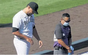  ?? Justin Edmonds, Getty Images ?? Colorado relief pitcher Carlos Estevez walks off the field after getting hit in the hand by a ground ball that ended the game against the Texas Rangers on Aug. 16.