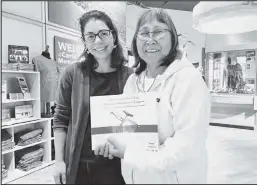  ??  ?? Amy Phillips-Chan and Yaayuk Stimpfle with the book “Our Stories Etched in Ivory”, a collaborat­ive publicatio­n between the Smithsonia­n Arctic Studies Center, Carrie McLain Museum and Bering Strait community members.