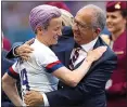  ?? ELSA — GETTY IMAGES ?? Megan Rapinoe, shown hugging U.S. Soccer President Carlos Cordeiro, and her U.S. women teammates have been paid more than their male counterpar­ts, according to U.S. Soccer.