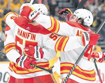  ?? REUTERS ?? Calgary Flames players celebrate after a goal by defenceman Noah Hanifin (55) during the third period against the Nashville Predators at Bridgeston­e Arena recently.