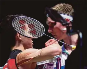  ?? AFP PIC ?? Lee Zii Jia (left) shakes hands with runner up Viktor Axelsen after their All England singles final on Sunday.