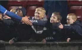  ??  ?? Kids reach out to high five their favourite players at a match