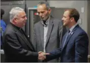  ?? ERIC BONZAR — THE MORNING JOURNAL ?? Mayor Chase Ritenauer, right, and Lorain County Commission­er Ted Kalo, center, meet with Bishop Nelson J. Perez, during the dedication ceremony in Lorain, Oct. 31.