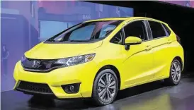  ?? Honda photos ?? The 2015 Fit debuts with a sleek, modern and sporty exterior style. A more aggressive front fascia showcases a new grille and headlight design. Larger 16-inch tires outfitted with a new 5-spoke wheel design give the Fit a planted and sporty stance.