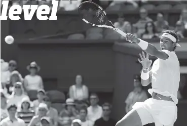  ?? ASSOCIATED PRESS PHOTOS ?? Rafael Nadal returns a shot to Karen Khachanov during their third-round match Friday at Wimbledon. Nadal won 6-1, 6-4, 7-6(3) and has victories in 28 straight completed sets in Grand Slam events.