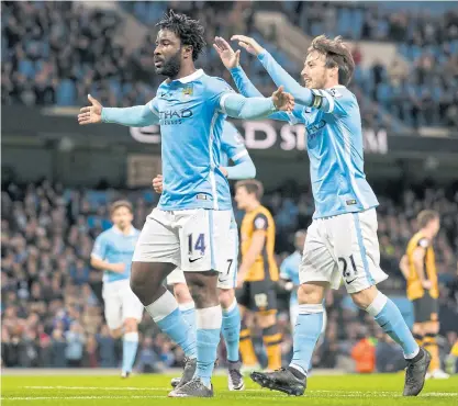  ??  ?? Manchester City’s Wilfried Bony, left, celebrates scoring against Hull with David Silva.