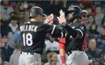  ?? MARY SCHWALM/AP ?? AJ Pollock congratula­tes Luis Robert after scoring on Robert’s two-run homer in the third inning.