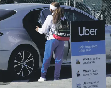  ?? AP ?? A passenger about to board an Uber vehicle at Los Angeles Internatio­nal Airport. The company’s business is recovering