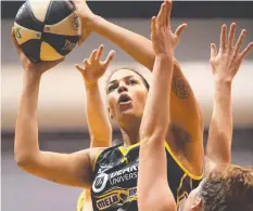  ??  ?? TOWER OF POWER: Liz Cambage scores at The Arena last night.