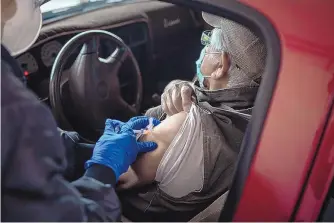  ?? ROBERTO E. ROSALES/JOURNAL ?? An elderly man receives his booster vaccine Wednesday at the Sandoval County Emergency Operations facility, which administer­ed 200 doses of COVID-19 vaccine Wednesday morning.