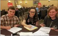  ?? PAUL POST — PPOST@DIGITALFIR­STMEDIA.COM ?? Saratoga Springs residents Bryce Coss, Anna Sawka and Karleigh MacMillan, left to right, fill out applicatio­ns during a Saratoga Race Course Job Fair on Friday. About 2,500 people work at the track each summer.