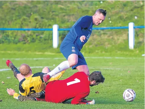  ??  ?? This effort by Lochee United’s Paddy Deane (blue) was ruled out because of an infringeme­nt against a Pumphersto­n player.