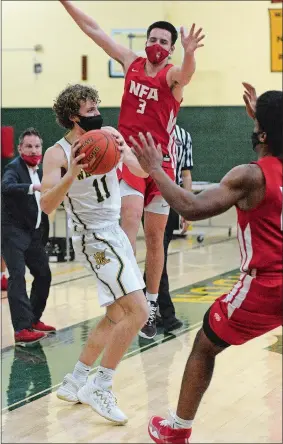  ?? DANA JENSEN/THE DAY ?? New London’s Sean Raymond (11) looks to pass the ball against the defense of NFA’s Jayden Francis (3) and Jared Martin (11) during Friday night’s season opener at Conway Gym in New London where the Whalers beat the Wildcats 57-54. Visit www.theday.com to view a photo gallery.