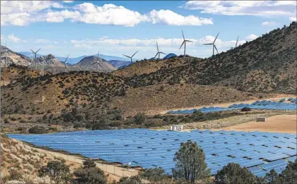  ?? Irfan Khan Los Angeles Times ?? SOUTHERN California Edison, which serves 15 million people, got 45% of its power from climate-friendly sources last year and has called for an 80% clean grid statewide by 2030. Above, wind turbines and solar energy panels in the Tehachapi Mountains in 2021.