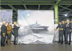  ?? CP PHOTO ?? Shipbuilde­rs and Irving employees unveil the design of 15 new Canadian Surface Combatants to be built at Irving Shipbuildi­ng’s Halifax shipyard with Lockheed Martin Canada as the designer in Halifax on Friday.