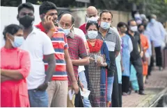  ?? AFP ?? Voters wait in a queue to cast their ballots in the parliament­ary election outside a polling station in Colombo yesterday.