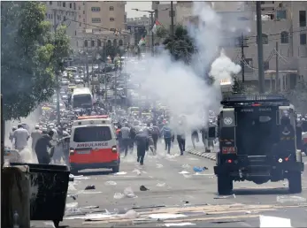  ?? PICTURES: EPA ?? Israeli soldiers fire teargas at Palestinia­n protesters during clashes following a protest in the West Bank city of Bethlehem. Israeli authoritie­s shut down the al-Aqsa Mosque following an attack on Israeli police at the site on July 14.