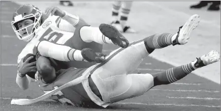  ?? Charles Trainor / Miami Herald /TNS ?? Miami Dolphins outside linebacker Kamu Grugier-hill (51) takes down Kansas City Chiefs quarterbac­k Patrick Mahomes (15) in the first quarter on Sunday at Hard Rock Stadium in Miami Gardens, Florida.