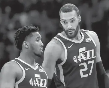  ?? Duane Burleson Associated Press ?? JAZZ PLAYERS Rudy Gobert (27) and Donovan Mitchell tested positive for the coronaviru­s. “We are all learning more about the seriousnes­s of this situation,” Mitchell wrote in an Instagram post Thursday.