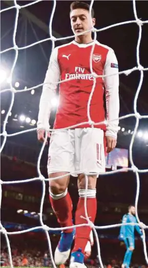  ?? REUTERS PIC ?? Arsenal’s Mesut Ozil looks dejected after a Bayern goal in their Champions League last 16, second leg match on Tuesday.