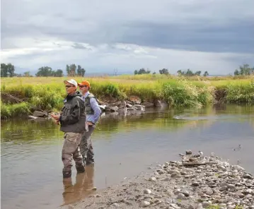  ?? (Reuters) ?? MEN FISH near Bozeman, Montana, a city that is home to a small Jewish community.