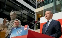  ?? PHOTO: AP ?? German Social Democratic Party (SPD) treasurer Dietmar Nietan, left, and temporary party leader Olaf Scholz, right, announce that the members of the Social Democratic Party voted for a new coalition with Chancellor Angela Merkel’s conservati­ve block at the party headquarte­rs in Berlin.