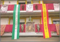  ??  ?? Balconies are decorated with Catholic religious banners during the Holy Week in Seville.