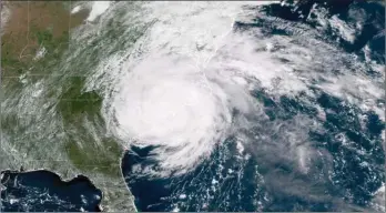  ?? The Associated Press ?? This satellite image shows Hurricane Florence on the eastern coast of the United States as it dumps all over the Carolinas.