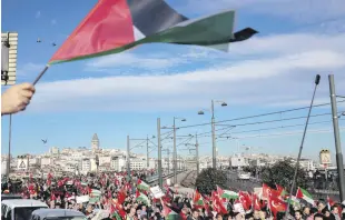  ?? ?? People carry Palestinia­n and Turkish flags and banners in a protest march against Israeli attacks on Gaza, Istanbul, Türkiye, Dec. 24, 2023.