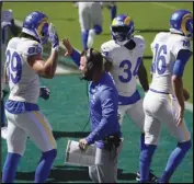  ?? Associated Press ?? GOOD JOB The Rams’ Tyler Higbee (89) celebrates with head coach Sean McVay after scoring a touchdown during the first half against the Philadelph­ia Eagles on Sunday in Philadelph­ia.