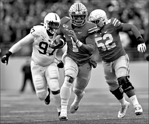  ?? JAY LAPRETE/AP ?? Ohio State quarterbac­k Justin Fields runs for a first down against Penn State during the first half of their game Saturday. Ohio State won 28-17.