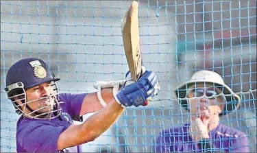  ??  ?? Sachin Tendulkar tests his timing under the watchful eyes of coach Duncan Fletcher at the Eden Gardens in Kolkata on Tuesday. Tendulkar has been having a lean run of late.