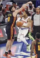  ?? Jason Decrow / Associated Press ?? The Knicks' Derrick Rose goes to the basket against the Hawks' Danilo Gallinari (8) during the third quarter on Monday in New York.