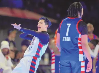  ?? ASSOCIATED PRESS ?? Actor Dylan Wang reacts near NFL player CJ Stroud after hitting a 3-pointer during the second half of the NBA All-Star Celebrity Game on Friday in Indianapol­is.