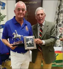  ?? ?? Winner Norman Walker is presented with the Inniskilli­ng Trophy by Colonel (retd.) Richard Kinsella Bevan.