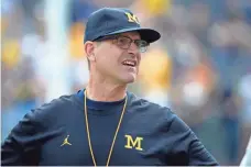  ?? RICK OSENTOSKI, USA TODAY SPORTS ?? Jim Harbaugh has gone 10-3 in each of his two seasons and lured top recruits since taking over as Michigan coach.