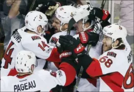  ?? MICHAEL DWYER — THE ASSOCIATED PRESS ?? The Ottawa Senators including, Clarke MacArthur (16), Alex Burrows (14), Mike Hoffman (68) and Jean-Gabriel Pageau (44) celebrate after defeating the Boston Bruins 3-2 during overtime in game six of a first-round NHL hockey Stanley Cup playoff series,...