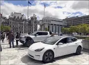  ?? Will Waldron / Times Union ?? Electric vehicles are parked on the Empire State Plaza in Albany on Wednesday as lawmakers push for a bill aimed at increasing sales of zero-emission vehicles in New York.