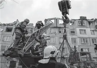  ?? Evgeniy Maloletka/associated Press ?? Rescue workers clear the rubble of a residentia­l building destroyed Wednesday by a Russian rocket in Pokrovsk, Ukraine. Local authoritie­s say two people were killed and 12 injured.