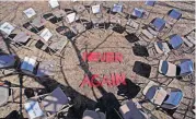  ?? [CHARLES KRUPA/THE ASSOCIATED PRESS] ?? Two rings of chairs encircle the words “NEVER AGAIN” in a silent protest on the 19th anniversar­y of the Columbine High School shooting Thursday outside Trinity High School in Manchester, N.H. The inner ring chairs have names of the Columbine victims,...