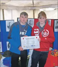  ??  ?? Grant Graham and Neil Wilson holding the memorial plaque that will be placed in Blarbuie Woodland.