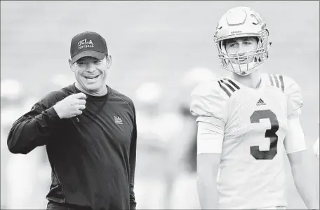  ?? Photograph­s by
Wally Skalij
Los Angeles Times ?? UCLA COACH
Jim Mora and freshman quarterbac­k Josh Rosen share a laugh during the Bruins’ spring football game at the Rose Bowl.