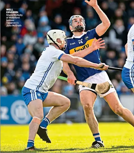  ?? Shane McNulty of Waterford tackles Tipperary’s John McGrath ?? WELL COVERED: