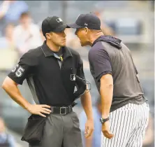  ?? Sarah Stier / Getty Images ?? Yankees manager Aaron Boone argues with plate umpire Brennan Miller on Thursday. Boone was ejected.